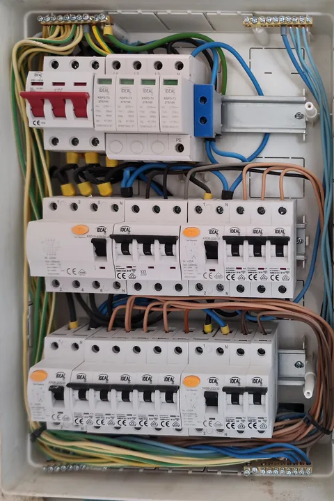 Wnętrze rozdzielnicy elektrycznej z aparatami zabezpieczającymi i przewodami w mieszkaniu w Dąbrowie Górniczej.